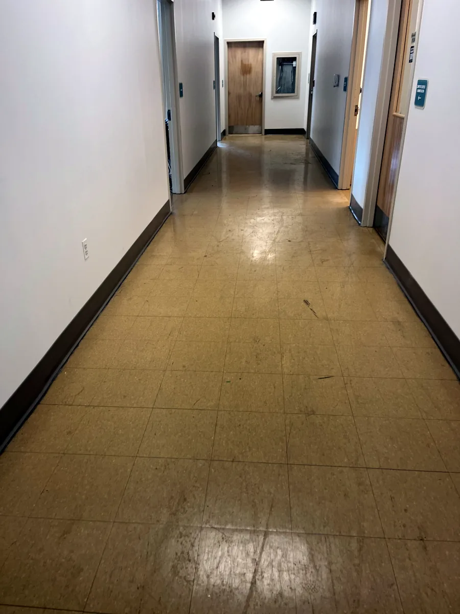 Office hallway floor before stripping and refinishing